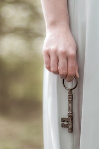 a woman is holding a key in her hand